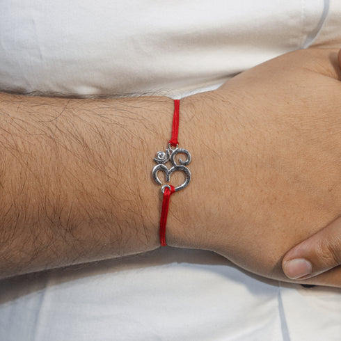 Zarkan OM With American Diamond Stone Silver Rakhi With Roli Chawal