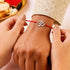 Zarkan OM With American Diamond Stone Silver Rakhi With Roli Chawal